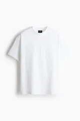Remera de algodón pesado, color blanco, con cuello redondo, hombros caídos y corte holgado.