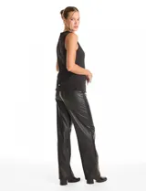 Chaleco sin mangas color negro, con cuello a la base y cierre frontal mediante botones metálicos dorados. Presenta un diseño entallado con lazo de ajuste en la espalda.