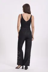Blusa sin mangas de tejido de punto fino con acabado brillante, escote en V y corte ajustado al cuerpo.