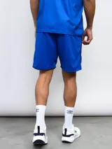 Short deportivo azul marino con laterales estampados con el escudo del Club Nacional de Football.