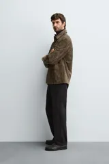 Pantalón de corte recto confeccionado en tejido de sarga con estructura diagonal. Presenta cintura elástica, bolsillos delanteros, bolsillos traseros de vivo y cierre frontal con cremallera y botón.