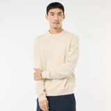Sweater de punto de cuello redondo, manga larga y diseño liso, con puños y ruedo acanalados.