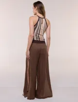 Musculosa de tejido de punto fino con diseño de rayas verticales en tonos marrón, beige y blanco. Posee escote halter con cuello redondo cerrado y ribetes marrones en contraste.