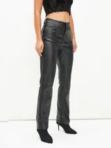 Pantalón recto de cuerina color negro, de tiro alto con bolsillos clásicos y cierre frontal con botón y cremallera.