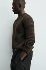 Jersey de punto regular fit, confeccionado en una mezcla de lana y fibra de alpaca. Presenta cuello redondo, manga larga y acabados en rib en puños y bajo.