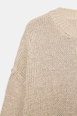Jersey de punto grueso color beige, con cuello redondo y manga larga, de diseño amplio y acabados en rib.