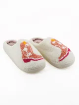 Pantuflas de estar por casa color blanco, confeccionadas en tejido tipo corderito, con diseño bordado de bota vaquera en tonos rosados y amarillos.