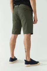 Bermuda de gabardina azul marino, corte chino, con bolsillos laterales y traseros.