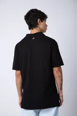 Chomba de manga corta en color blanco, con cuello clásico y cierre frontal de dos botones. Presenta un corte recto y diseño minimalista.