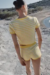 Shorts de punto a rayas horizontales en tonos amarillo y blanco, con cintura elástica.