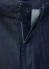 Pantalón de tiro alto con diseño wide leg, confeccionado en tejido de algodón y lyocell estilo denim. Presenta costuras verticales decorativas, bolsillos laterales y cierre oculto con botón, gancho y cremallera.