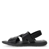 Sandalias de cuero negro con diseño de tiras cruzadas y ajuste mediante velcro en el talón. Presentan una plantilla texturizada y suela de goma antideslizante.