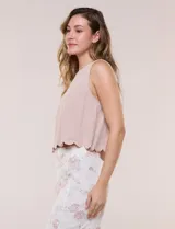 Top corto sin mangas de lino y viscosa color rosado, con escote redondo y detalle de ruedo festoneado.