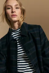 Polera de cuello alto y manga larga, confeccionada en tejido elástico con diseño de rayas horizontales en tonos azul marino y terracota.