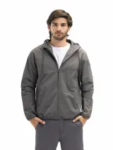 Campera rompevientos de nylon color negro, con capucha ajustable, cierre frontal, bolsillos laterales con cierre y forro interno de red para mayor ventilación.