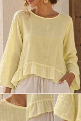 Blusa de lino color amarillo claro, con cuello redondo, mangas largas acampanadas y detalle de volado en el ruedo.