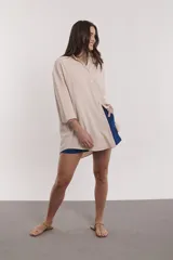 Camisa beige de corte amplio, con cuello clásico y mangas 3/4.