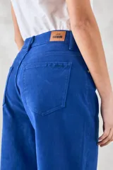 Pantalón jean azul de corte ancho, con tiro medio y bolsillos delanteros y traseros.