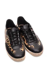 Zapatillas deportivas de cuero negro con estampado animal print y detalles plateados en el talón.