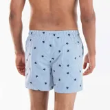 Short de baño con diseño de rayas verticales blancas y celestes, decorado con pequeños estampados de tortugas en color azul marino. Cuenta con cintura elástica y cordón ajustable blanco.