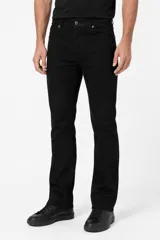 Pantalón jean negro de corte skinny y tiro bajo, con diseño de cinco bolsillos y cierre frontal con botón y cremallera.