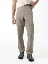 Pantalón técnico Merrell de trekking, color beige, desmontable con cierre para convertirlo en bermuda. Posee cintura con cinturón ajustable y bolsillos con cierre.