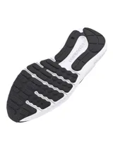 Championes de running Under Armour modelo Charged Surge 4, color negro con entresuela blanca. Presentan una parte superior de malla transpirable con detalles sintéticos para mayor soporte, cuello acolchado y tecnología Charged Cushioning en la entresuela para una amortiguación superior.