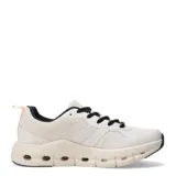 Championes deportivos de diseño moderno con capellada en combinación de malla y material sintético en tonos beige y crema. Presenta cordones negros, suela de plataforma con perforaciones decorativas y detalle de tirador naranja en el talón.