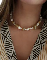 Collar corto con cuentas de piedra irregulares en tonos blanco, amarillo y transparente, y pequeñas perlas.