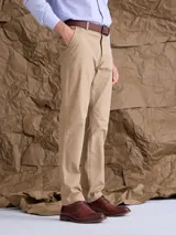 Pantalón de gabardina color azul marino, de corte recto y estilo clásico, con cierre de botón y cremallera, y trabillas para cinturón.