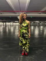 Vestido midi con estampado abstracto en tonos verde lima y negro, con cuello alto y volantes en la falda.