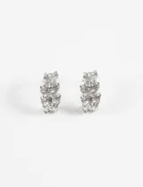 Aros tipo argolla de tamaño pequeño, con superficie de textura irregular y acabado brillante en tono plateado.