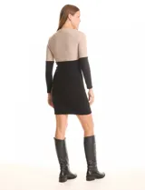 Vestido corto de tejido de punto acanalado, con diseño color block en tono arena jaspeado en la parte superior y negro en la parte inferior. Tiene cuello redondo y mangas largas.