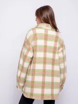 Sobrecamisa a cuadros color verde, beige y rosa, de tela tipo corderito, con cuello camisero, cierre frontal con botones y dos bolsillos con solapa en el pecho.