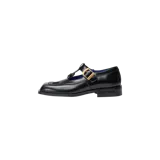 Zapatos tipo Mary Jane Eme Studios modelo Daisy, de color negro con acabado brillante y 100% piel auténtica. Presentan un diseño estructurado con puntera cuadrada, correa en T con hebilla metálica dorada y suela con la marca grabada en el lateral.
