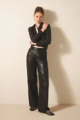 Pantalón de cuero ovino con corte oxford y tiro medio. Presenta diseño estilo jeanero con bolsillos delanteros y traseros, cierre y botón metálico frontal.