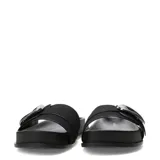 Sandalias de mujer Miss Carol modelo Zafira, color negro, tipo pala con suela plana y tira ancha decorada con una gran hebilla metálica plateada.