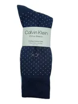 Pack de 4 pares de medias largas de vestir Calvin Klein, con diferentes diseños: azul marino con lunares, celeste liso, gris a rayas horizontales y negro liso.