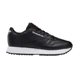 Championes Reebok de cuero negro con suela ondulada blanca.