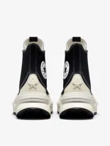 Championes de caña alta Converse Run Star Legacy CX, con diseño de plataforma irregular y voluminosa. Presentan cuerpo de lona negra con costuras blancas a contratono, cordones de algodón y el icónico parche de estrella en el lateral.