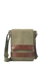 Morral versátil de tela canvas gris con detalles en cuero sintético marrón. Cuenta con tapa frontal con broches magnéticos, bolsillo tipo guantera bajo la tapa, división interna desmontable con velcro y correa larga regulable.