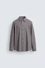 Camisa de corte regular fit confeccionada en algodón, con diseño de rayas verticales finas, cuello italiano, manga larga con puños abotonados y cierre frontal de botones.