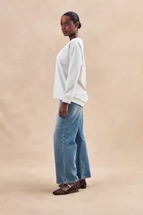 Sweater gris melange de algodón peinado con poliéster, de calce oversize, cuello redondo y mangas largas.