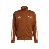 Campera deportiva Adidas House of Tiro color marrón, con cierre frontal completo, cuello alto, bolsillos laterales y las icónicas tres rayas blancas en las mangas. Presenta el logo de la marca y un diseño gráfico en el pecho.