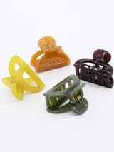 Set de cuatro mini broches para el pelo tipo pinza, en colores amarillo, verde, marrón y negro.