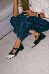 Zapatos estilo Mary Jane de cuero con acabado acharolado y textura efecto croco en color marrón oscuro. Presentan punta cuadrada, cierre con tira en el empeine y taco cuadrado bajo.