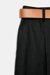 Pantalón tobillero azul marino de tiro medio, con pinzas delanteras, bolsillos frontales, falsos bolsillos con solapa en la espalda y cierre frontal con cremallera, botón y gancho. Incluye cinturón de cuero sintético tostado con hebilla metálica dorada.