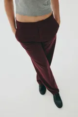 Pantalón sastrero de tiro alto, color bordó, con piernas rectas y pliegues marcados en el frente.