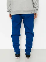 Pantalón de jogging azul con cordón ajustable en la cintura y gran estampado vertical de la marca en la pierna izquierda.