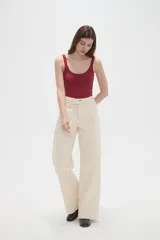 Pantalon de jean de corte ancho y tiro medio, en color natural, con cierre frontal y bolsillos laterales.